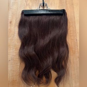 Brunette, hairpiece, never been worn. Human hair, easy to place, curl, and dye.